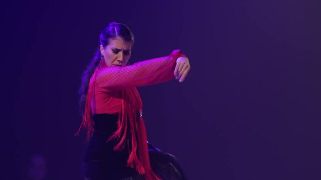 Close up of woman dancing flamenco on stage. Handheld