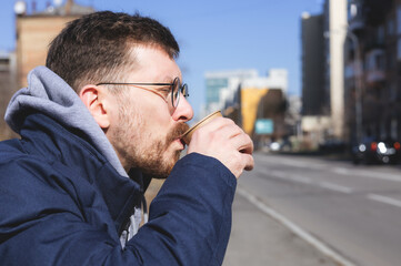 Young man enjoying coffee outdoors