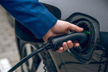 Man refilling his automobile with diesel in the automotive gas station