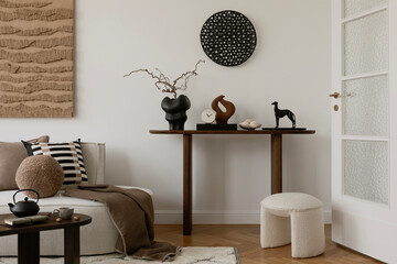 Elegant console table styling with artistic sculptures, ceramics, and decorative elements. A...