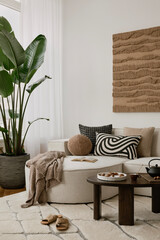 Cozy living room corner with a neutral-toned sofa, textured cushions, and a wooden coffee table. A...
