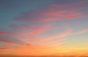 A beautiful sunset with pink and orange clouds in a blue sky