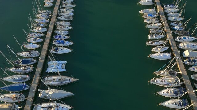 Aerial View of Marina with Sailboats and Yachts Docked in Calm Water