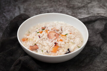 Boiled rice with octopus in white bowl