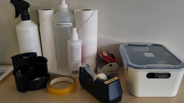 Shot of essential office supplies like tape, disinfectant spray, cleaning products, and paper towels