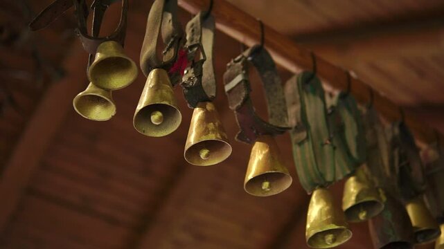 Old cow bells hanging in a house close-up
