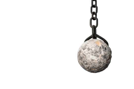 Heavy metallic wrecking ball hanging from a chain for demolition work