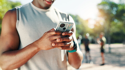 Hands, phone and runner at park typing for speed stats, challenge and monitor progress in nature. Fitness person, smartphone and mobile app for stopwatch, steps and break for workout in summer