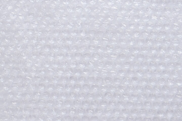 Air bubble wrap, top view. Transparent bubble wrap on light background. Close-up of bubble wrap....