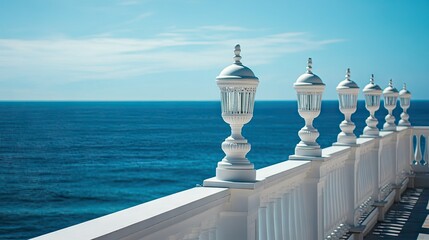 Fototapeta premium A row of elegant lanterns lining a seaside balustrade, leading the eye toward the open ocean.