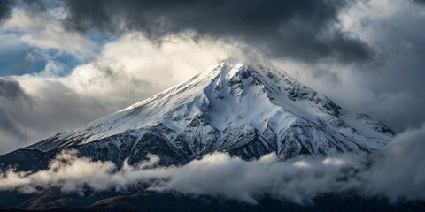 A majestic snow-capped mountain peak piercing through dramatic storm clouds, a breathtaking scene of raw nature's power and serene beauty in moody, atmospheric lighting.