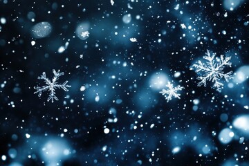Isolated snowflakes falling in dark blue, bokeh effect. Use for winter holiday, christmas, and new year themes.