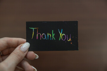 Hand holding a black card with 