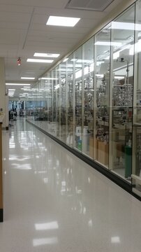 A Pristine and Highly Organized Modern Biopharmaceutical Laboratory Environment Showcasing Complex Equipment Behind Glass Walls, Demonstrating Cleanliness and Precision