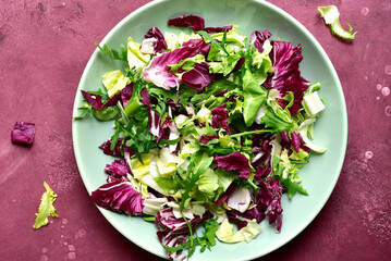Mix of fresh salad leaves on a plate. Top view with copy space.