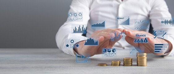 Stack of coins with a financial growth graphs.