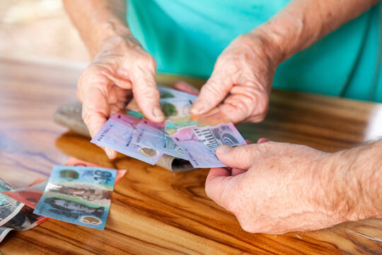Person handing over money in australian bank notes