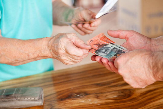 Person handing over money in australian bank notes