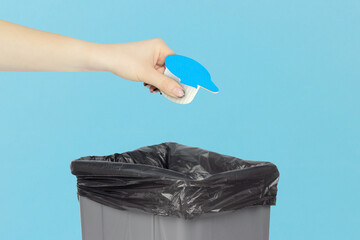 throw portion packs with cream in the trash can, portion packs with cream in hand in front of trash...