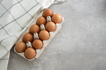 Chicken eggs lie in a tray on a light background. Fresh egg on morning breakfast. Concept farm...