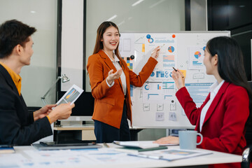 Businessmen with laptop, tablet pc computer and papers having discussion in modern office.