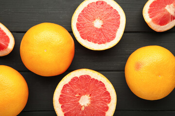 Fresh raw grapefruit on black wooden background