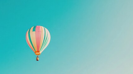 Fototapeta premium Colorful hot air balloon soaring in a clear blue sky.
