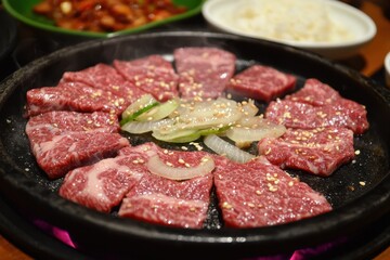 Bulgogi (South Korea) A sizzling plate of bulgogi featuring thinly sliced marinated beef