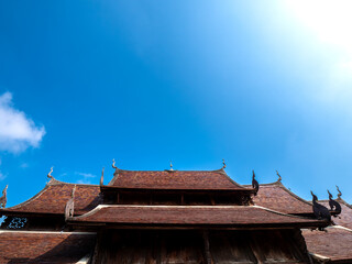 Golden Teak Temple Roof under Azure Sky: Lanna Heritage