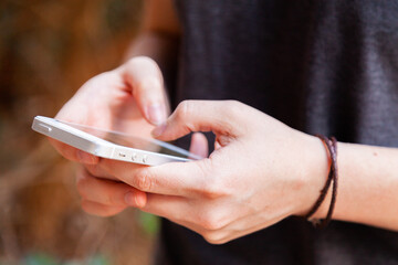 Teen using social media on mobile phone
