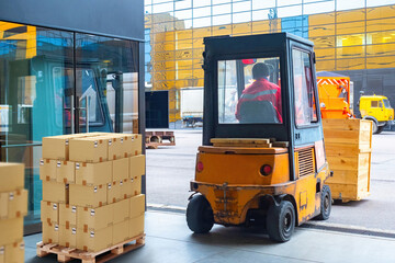 Warehouse center. Pallets with boxes in building. Forklift inside storage hangar. Cardboard parcels...