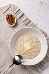 Oatmeal porridge with almond milk and a piece of butter
