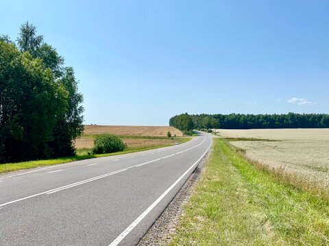 Scenic Highway Through Rural Countryside on Sunny Day