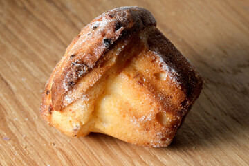 Deliciously baked muffin resting on a wooden surface