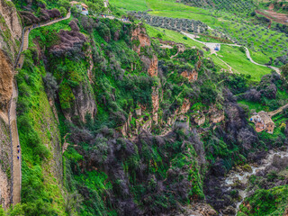 Ruins perched precariously on cliff face at Ronda, Andalusia, Spain.