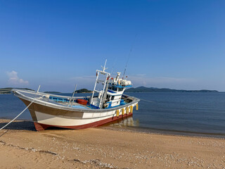 Docked Fishing Boat on a Sandy Shore