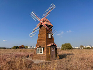 Wooden Windmill in a Field