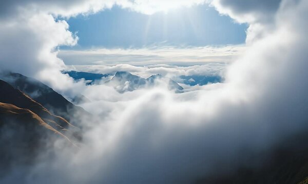 Mesmerizing aerial time-lapse showcasing clouds sweeping over dramatic mountain landscapes, illuminated by warm sunlight shining through the mist