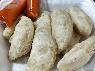 Cireng is an Indonesian street food, white semi-circular shaped made from starch flour and filled with seasoned shredded chicken.