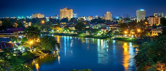 Fototapeta premium Spectacular urban skyline at night reflecting in the river in Phnom Penh