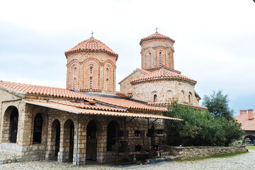 Fototapeta premium Historic Monastery of Saint Naum with Red-Tiled Roofs and Cylindrical Towers, Ohrid, North Macedonia