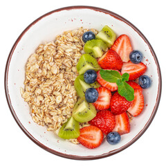 Oatmeal porridge in bowl topped with fresh berries isolated on white background. top view