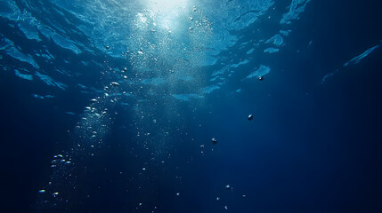 Obraz premium Underwater bubbles rising in deep blue ocean wallpaper background nature scene tranquil viewpoint