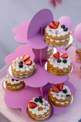 Colorful dessert display at a cheerful party setting with cakes and berries