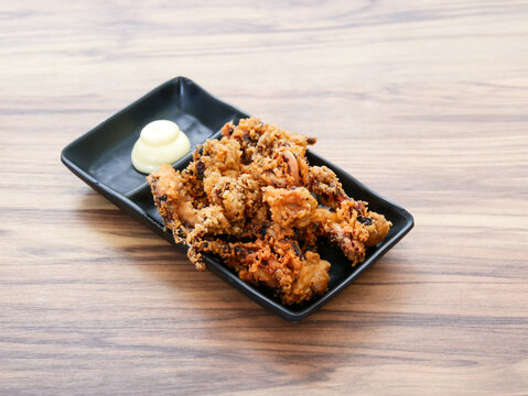 Ika Geso Karaage or Fried Squid Tentacles with Mayonnaise served in tray dish isolated on table side view of Japanese food