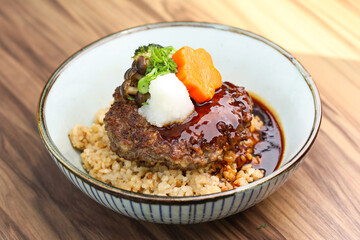 Japanese Hamburg Steak Rice bowl with gravy and vegetables served in bowl isolated on table closeup side view of Japanese food