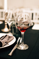 Glass of red wine on a black tablecloth