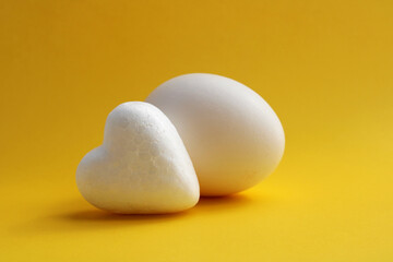 Heart next to a chicken egg