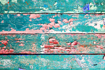 Peeling paint of turquoise color on the wooden texture surface, texture background with peeling...