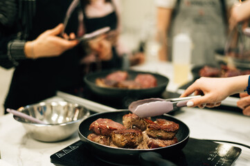 Filet mignon is fried in a pan